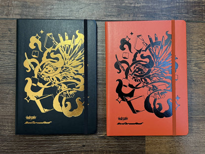 Leuchtturm1917 Tobyato Edition A5 Medium Notebook in fox red and black, featuring a cover design of a raven with books and typewriter keys, symbolizing knowledge and resilience.